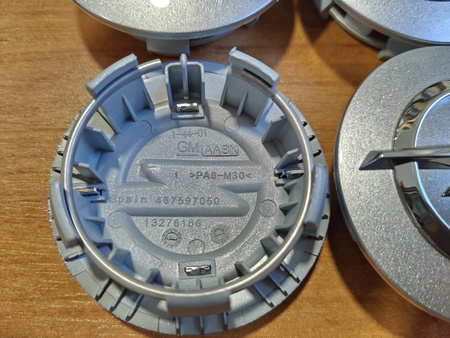 Oryginał dekielki dekle zaślepki kołpaczki Opel 13276166 srebrne