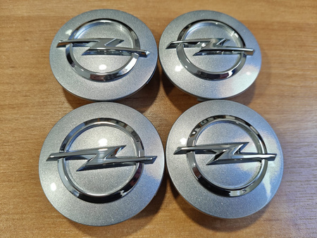 Oryginał dekielki dekle zaślepki kołpaczki Opel 13276166 srebrne